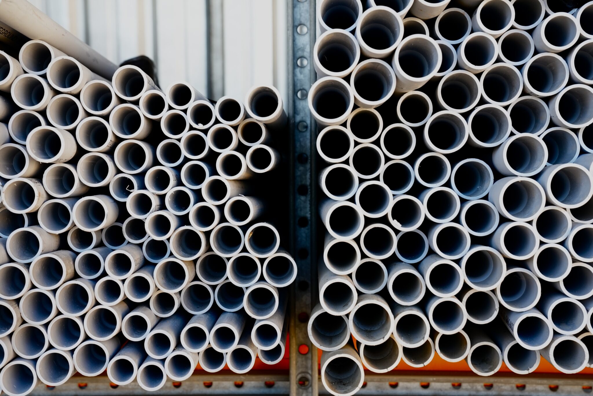 Stacked PVC electrical conduit in the Lake County Electric Supply yard
